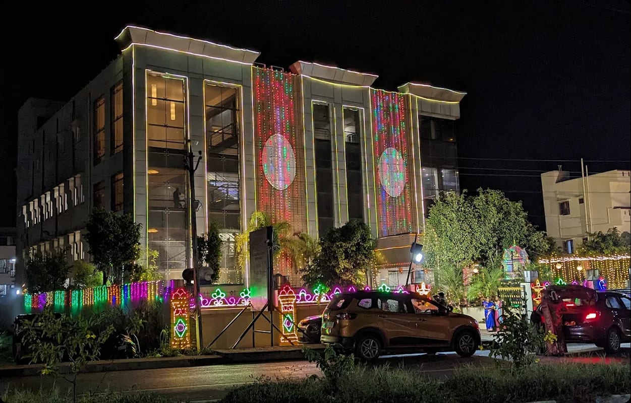 Sri Sai Convention Hall lit for an evening function, projected decoration across the facade, Jayanagar 9th Block, Bengaluru